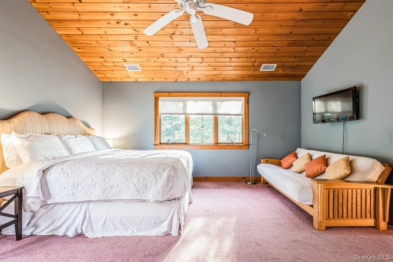292 Little Fresh Pond Road Southampton, NY 11968 - Photo 24 of 46 Primary Bedroom with high ceiling, ceiling fan, and wooden ceiling