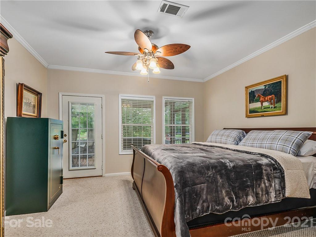 1219 North Ridge Road Hendersonville, NC 28792 - Photo 14 of 48 a bedroom with a bed and a large window
