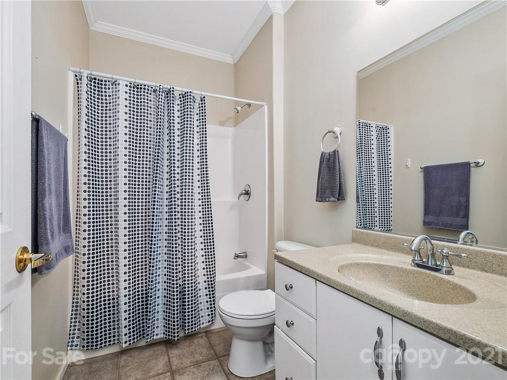 1219 North Ridge Road Hendersonville, NC 28792 - Photo 22 of 48 a bathroom with a granite countertop sink toilet and shower