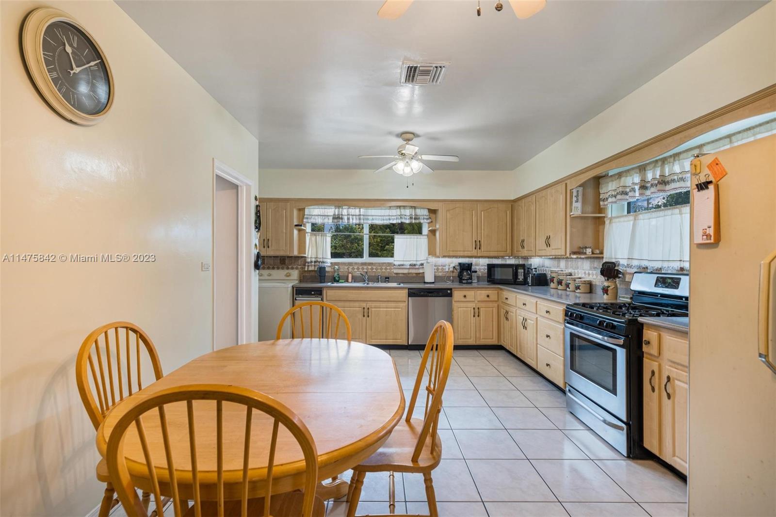 280 Eucalyptus Drive Hialeah, FL 33010 - Photo 18 of 38 a kitchen with stainless steel appliances granite countertop a kitchen island a stove a table and chairs