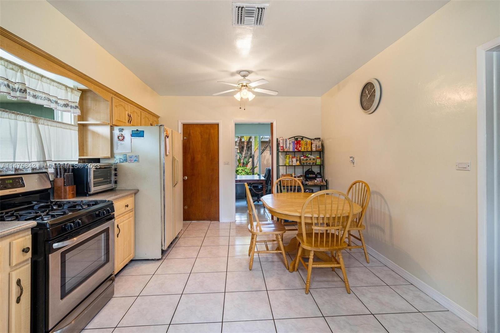 280 Eucalyptus Drive Hialeah, FL 33010 - Photo 19 of 38 a dining room with furniture and a kitchen view