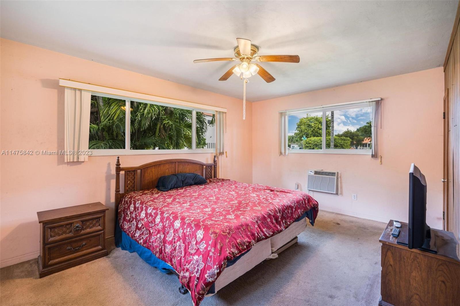 280 Eucalyptus Drive Hialeah, FL 33010 - Photo 33 of 38 a bedroom with a bed and a flat tv screen on dresser