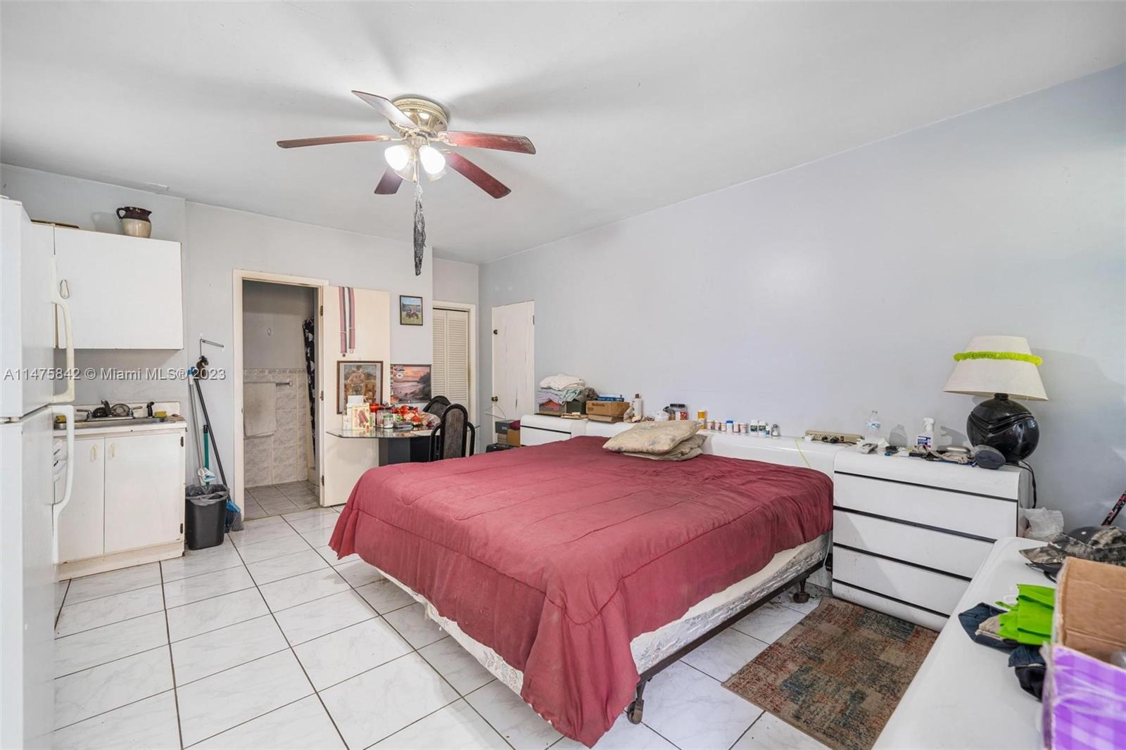 280 Eucalyptus Drive Hialeah, FL 33010 - Photo 36 of 38 a bedroom with a bed and a chandelier