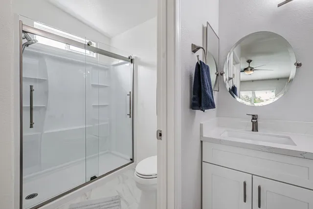 a bathroom with a sink a mirror and shower