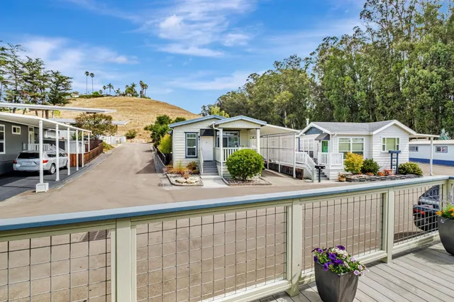 a view of a house with wooden deck