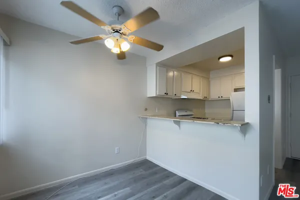 a view of kitchen with wooden floor and window