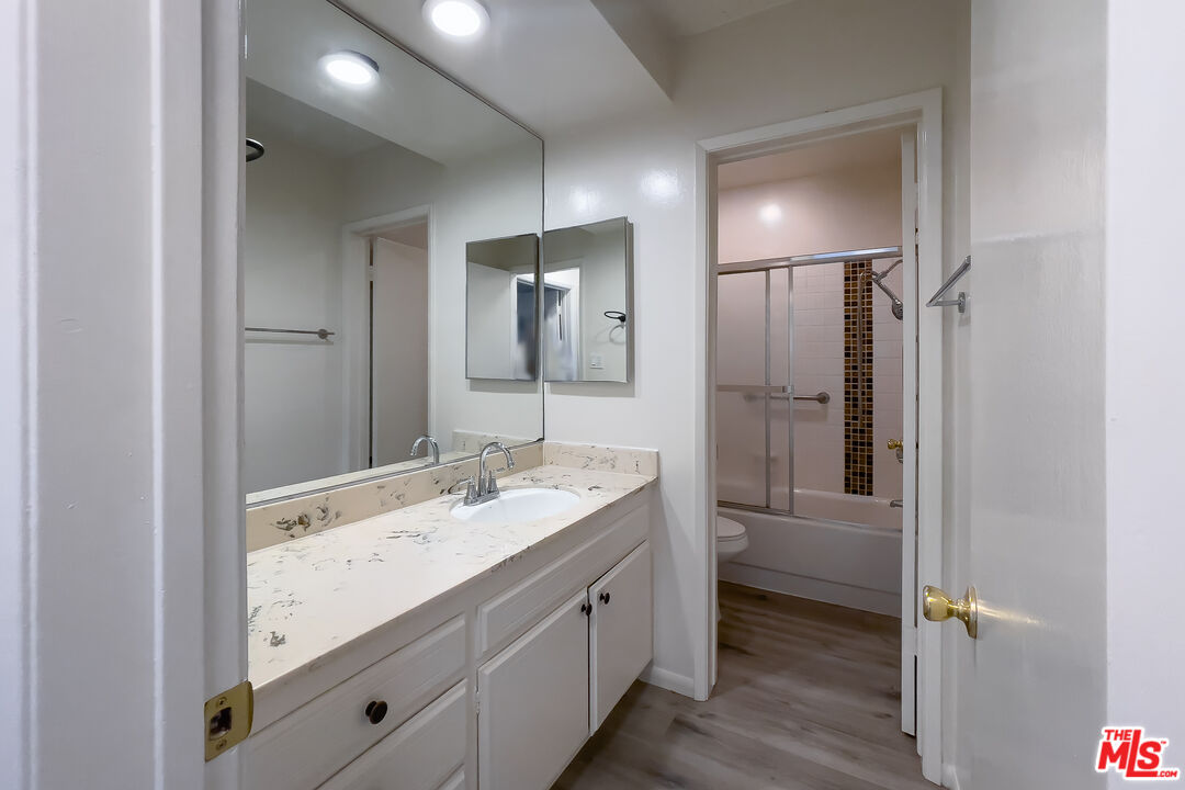 3607 Clarington Avenue, Unit 2 Los Angeles, CA 90034 - Photo 9 of 11 a bathroom with a double vanity sink and mirror with shower
