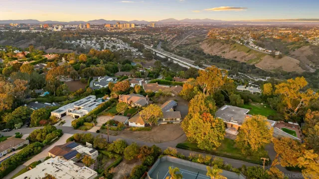 an aerial view of residential building with parking