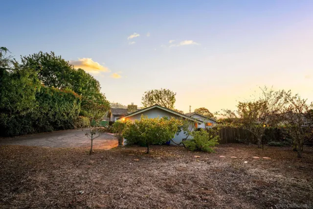 an aerial view of residential house with parking