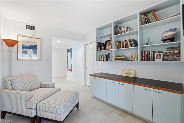 a living room with furniture and a book shelf