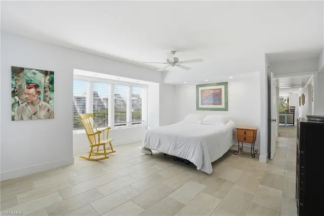 a spacious bedroom with a bed and a table in it