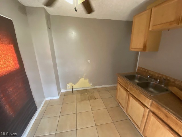 921 Rudyard Road Cleveland, OH 44110 - Photo 23 of 31 Kitchen with brown cabinets and light tile floors
