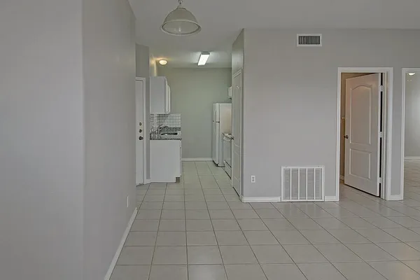 a kitchen with white cabinets and white appliances