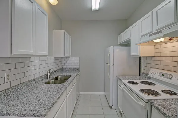 a kitchen with a refrigerator stove and cabinets