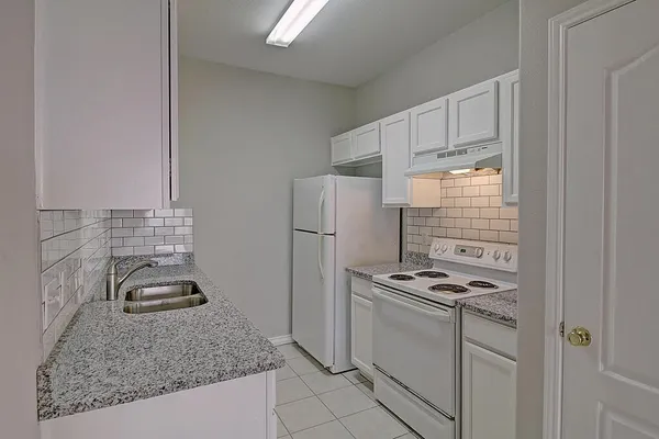 a kitchen with a sink and cabinets