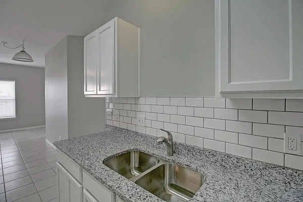 a stove top oven sitting inside of a kitchen
