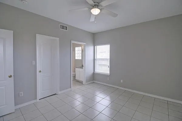 a view of an empty room with a fan