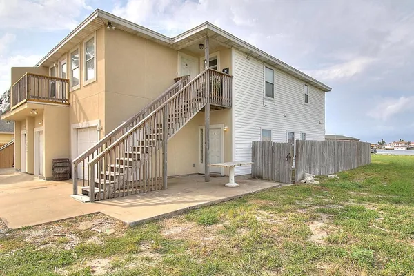 a view of a house with wooden floor and a yard
