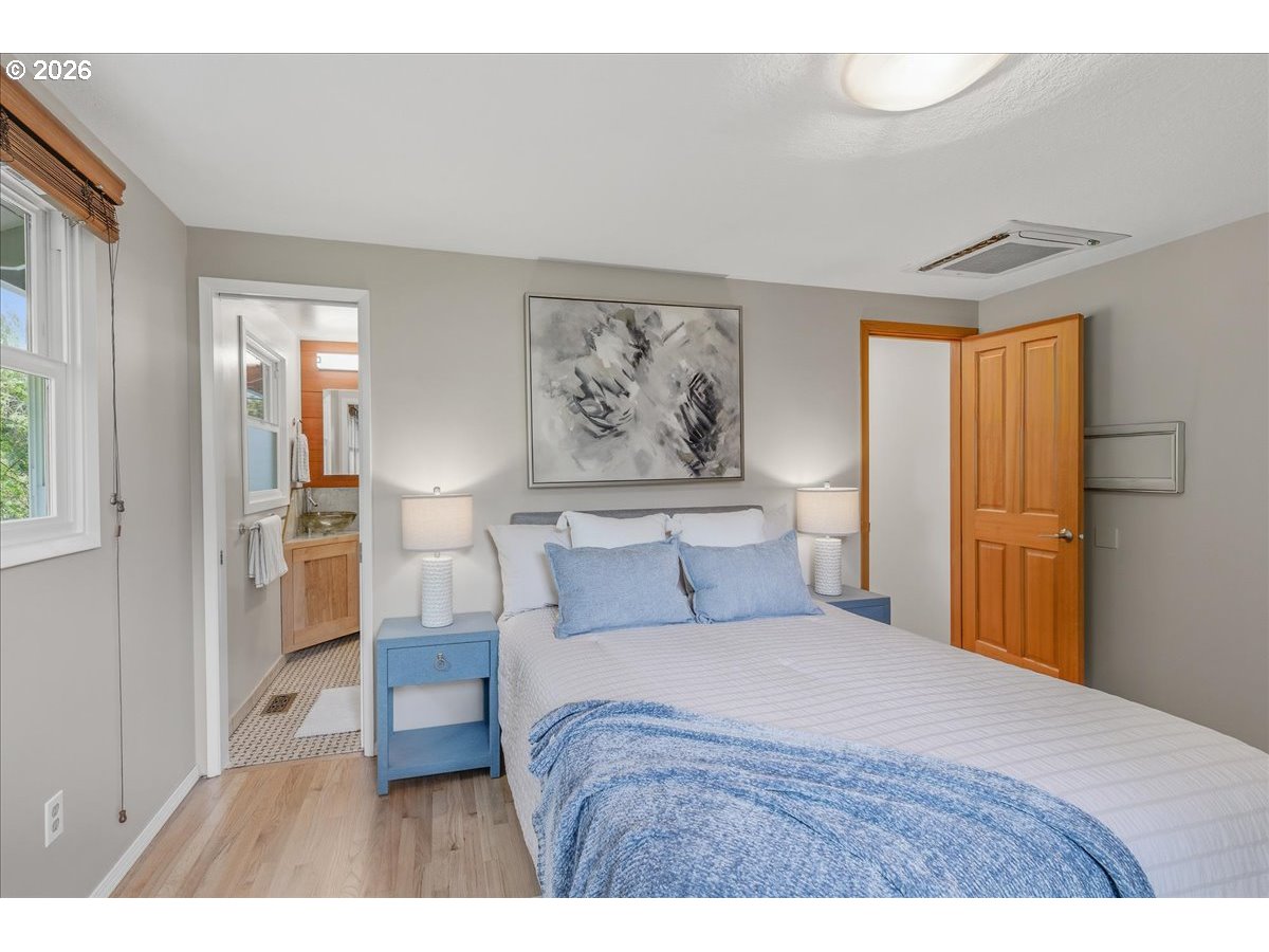 3130 Southwest 116th Avenue Beaverton, OR 97005 - Photo 10 of 44 a bedroom with a bed and a painting on the wall