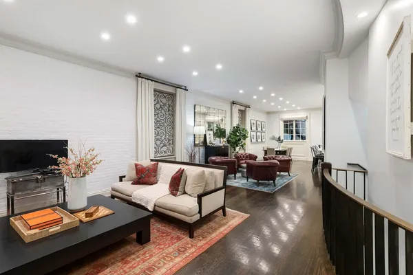 a living room with furniture and a stairs