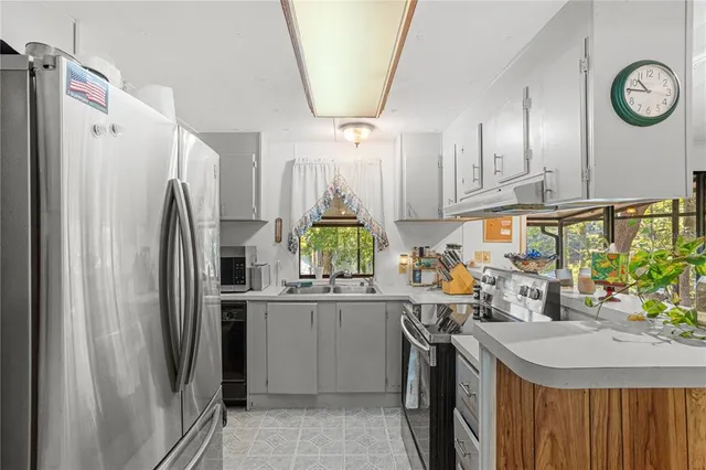 a kitchen with stainless steel appliances a refrigerator and a stove