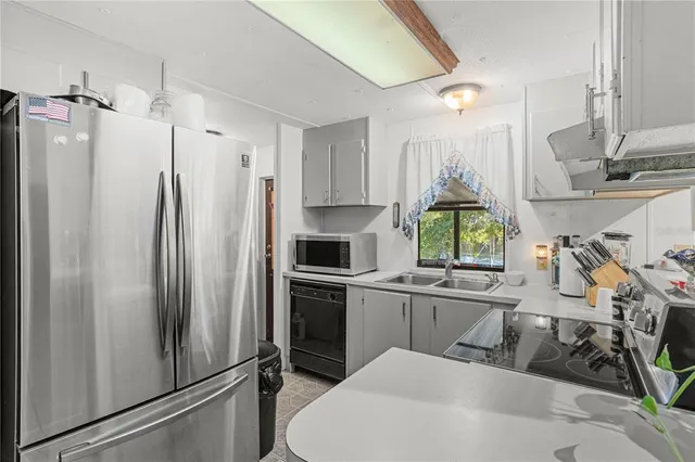 a kitchen with stainless steel appliances a refrigerator and a sink