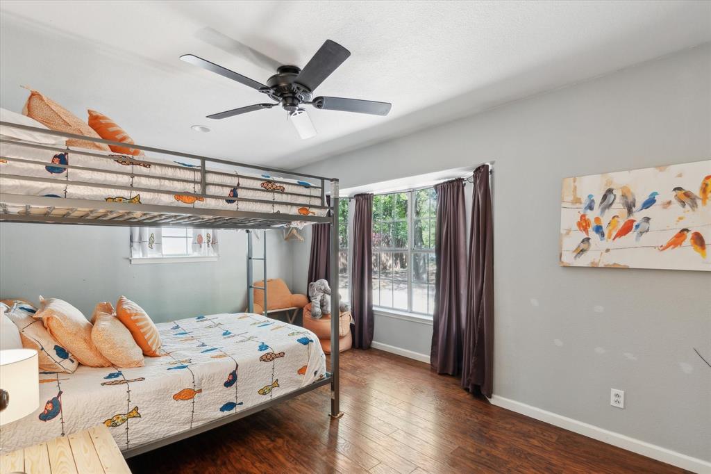 168 Barker Lane Waco, TX 76705 - Photo 12 of 31 a bedroom with a bed and wooden floor
