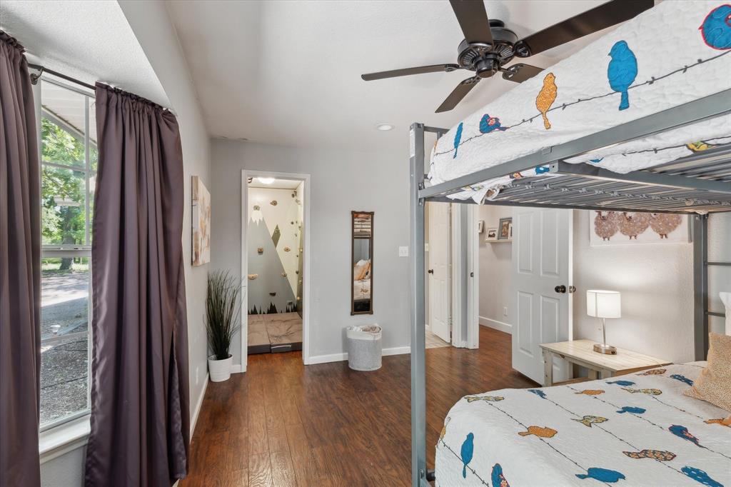 168 Barker Lane Waco, TX 76705 - Photo 13 of 31 a bedroom with a bed and a wooden floor