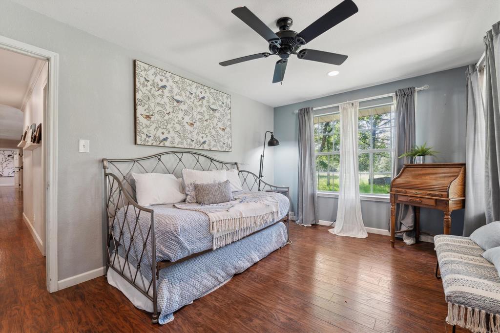168 Barker Lane Waco, TX 76705 - Photo 15 of 31 a spacious bedroom with a bed a couch and a window