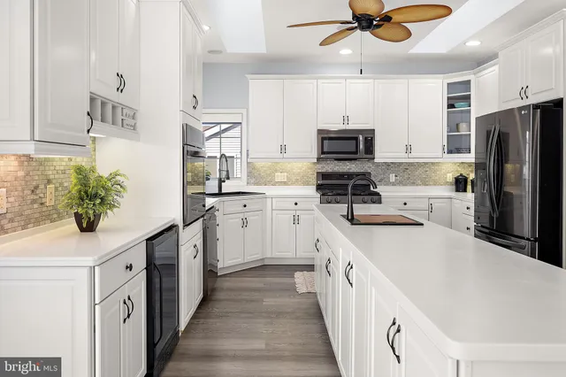 a bedroom with a large bed and a potted plant