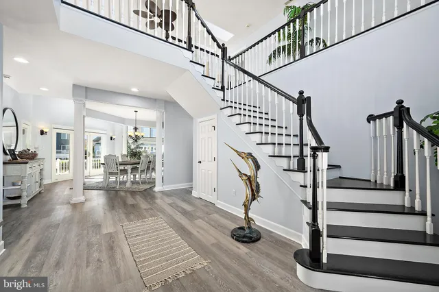 a view of entryway with wooden floor and stairs