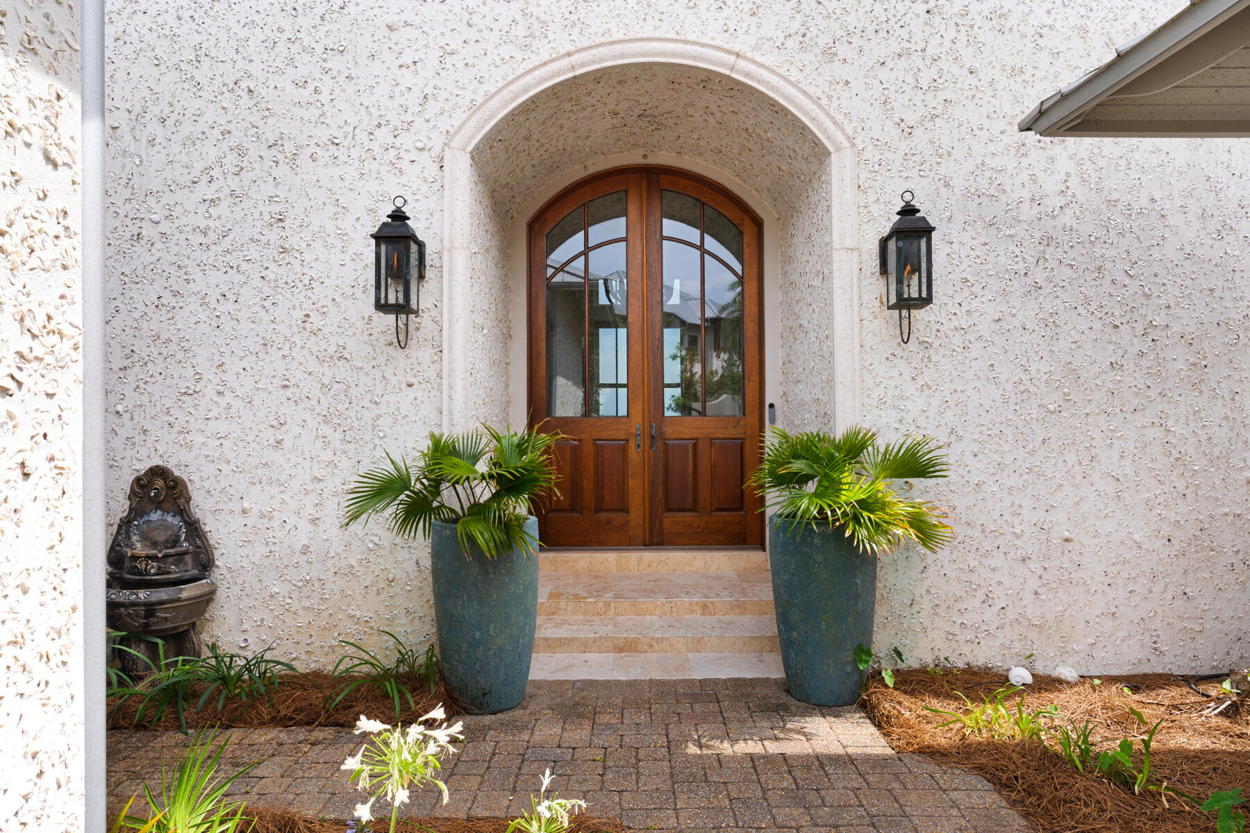 201 West Bermuda Drive Santa Rosa Beach, FL 32459 - Photo 5 of 146 a vase with flowers sitting on a floor in front of a door