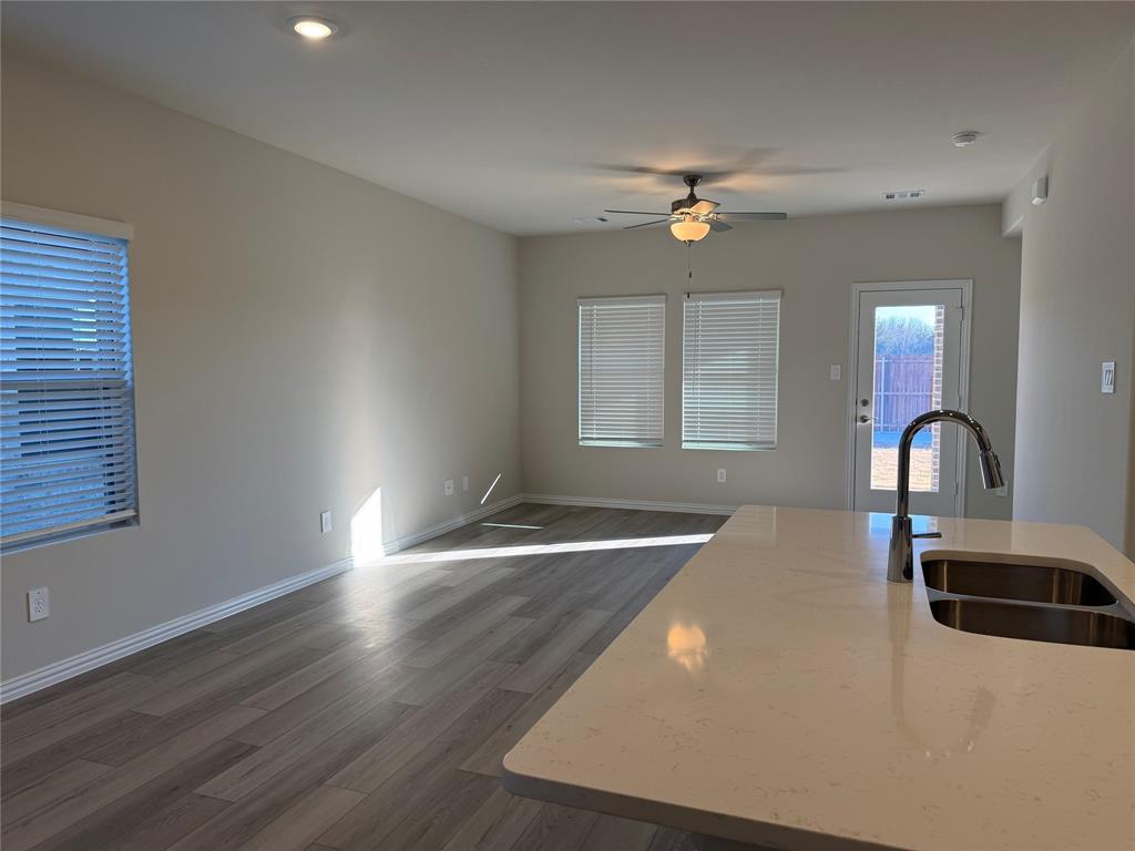 1736 Arches Road Anna, TX 75409 - Photo 18 of 18 Kitchen featuring a ceiling fan, light stone counters, dark wood-style flooring, open floor plan, and recessed lighting