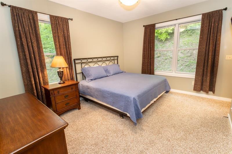 2226 County Line Road Champion, PA 15622 - Photo 14 of 33 a bedroom with a bed and large windows