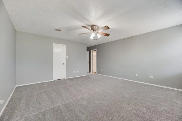 a view of an empty room with a fan