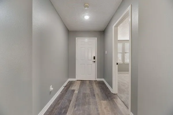 a view of hallway with wooden floor