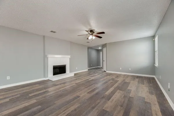 a view of an empty room with a fireplace