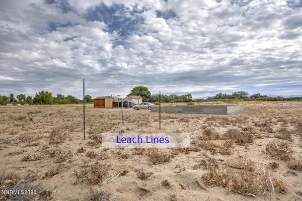 a view of a yard with wooden fence