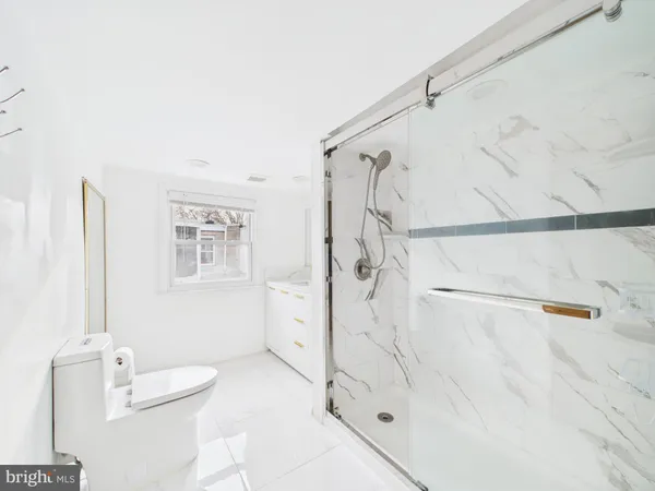 a bathroom with a shower and a sink