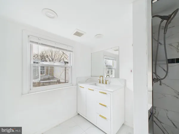 a room with a sink and a mirror