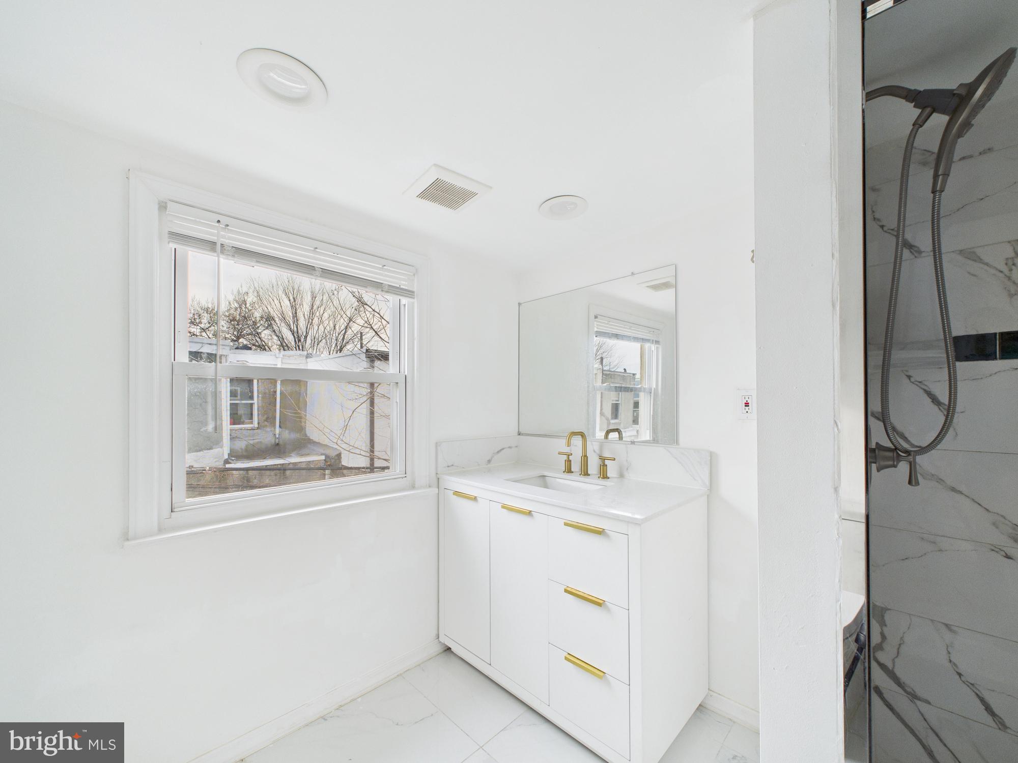 628 McClellan Street Philadelphia, PA 19148 - Photo 5 of 7 a room with a sink and a mirror