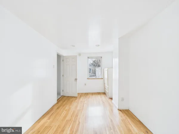 a view of a room with wooden floor and window