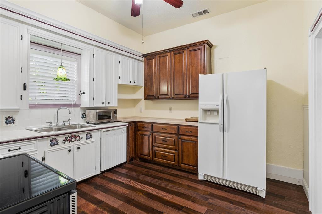 5824 Boone Street Sachse, TX 75048 - Photo 10 of 40 a kitchen with stainless steel appliances a refrigerator sink and cabinets