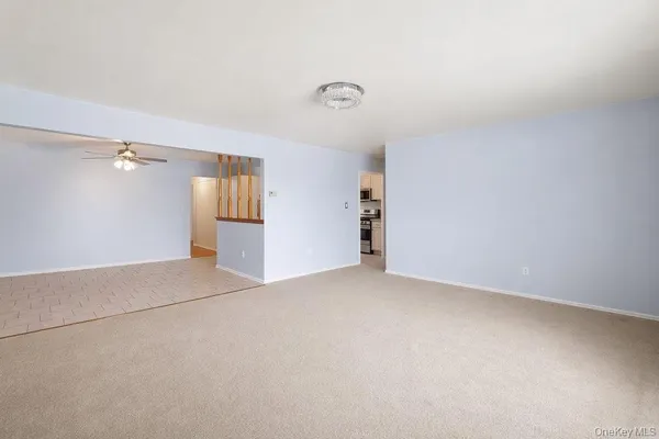 an empty room with windows and cabinet