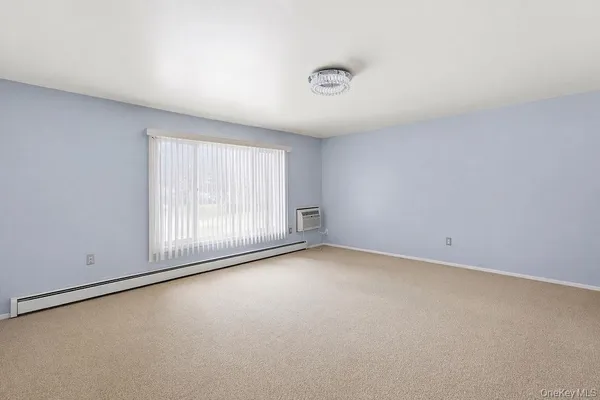 an empty room with a empty space and a window