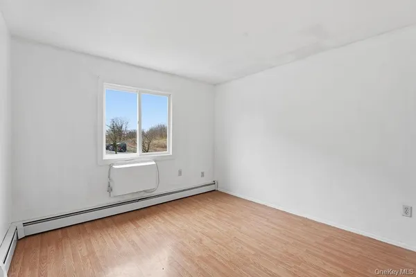 a view of room with window and hardwood floor