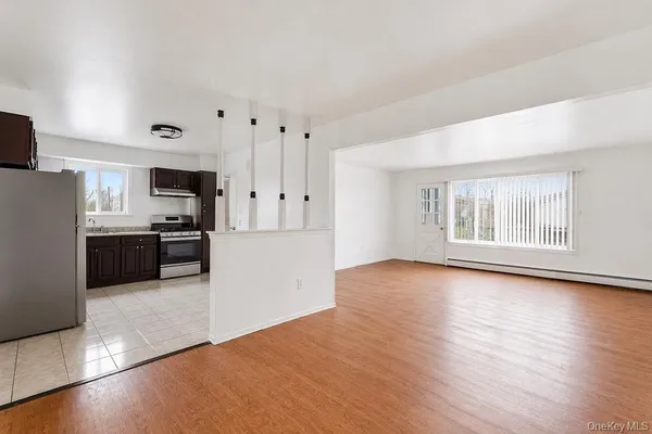 a kitchen with granite countertop a stove and a refrigerator