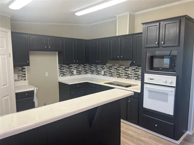 a kitchen with a sink and a refrigerator