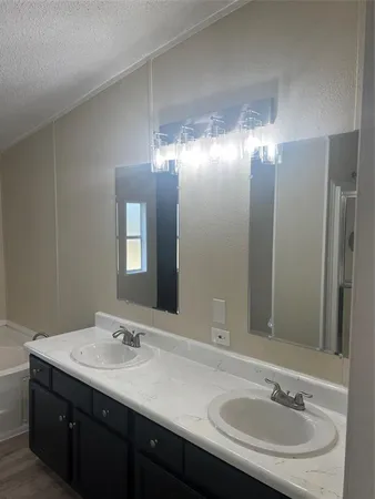 a bathroom with a glass shower door