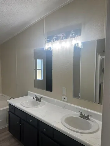 a bathroom with a glass shower door